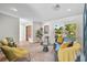 Stylish living room features a blue velvet sofa, hardwood floors, and abundant natural light at 577 Corwood Dr, Sarasota, FL 34234