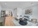 Bright living room featuring wood-look tile flooring, decorative painting, and comfortable seating area at 577 Corwood Dr, Sarasota, FL 34234