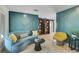 Interior living room with hardwood floors, colorful sofa and custom built-in bookshelves at 577 Corwood Dr, Sarasota, FL 34234