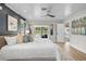 Bright main bedroom with white ceiling, neutral colors, access to the backyard and an ensuite bath at 577 Corwood Dr, Sarasota, FL 34234