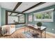 Inviting home office features a rustic desk, wood beams, and a cozy sitting area, perfect for work or relaxation at 577 Corwood Dr, Sarasota, FL 34234