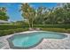 Inviting backyard pool surrounded by brick pavers and lush landscaping at 577 Corwood Dr, Sarasota, FL 34234