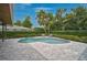 Inviting backyard pool with brick pavers, lush landscaping, and comfortable seating at 577 Corwood Dr, Sarasota, FL 34234