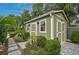 Side view of storage shed with double doors and lush landscaping at 577 Corwood Dr, Sarasota, FL 34234