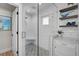 Stylish shower with glass enclosure, patterned tile floor, and convenient corner bench at 577 Corwood Dr, Sarasota, FL 34234