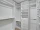 Spacious walk-in closet with custom shelving and drawers for optimal storage and organization at 577 Corwood Dr, Sarasota, FL 34234