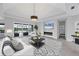 Elegant living room boasts a fireplace, tray ceiling, and sliding glass doors to the backyard at 659 Rosemary Cir, Bradenton, FL 34212