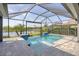 Resort-style pool with a spa, screened lanai, and serene lake view at 659 Rosemary Cir, Bradenton, FL 34212