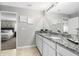 Bathroom features a double vanity with granite countertops and views into the main bedroom at 7130 Plantation St, Englewood, FL 34224