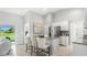 Bright, airy kitchen with granite counters, a center island with seating, and stainless steel appliances at 7130 Plantation St, Englewood, FL 34224