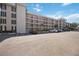 Residential condo building exterior with ample parking and manicured lawn at 7461 W Country Club N Dr # 207, Sarasota, FL 34243