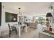 Bright living room featuring modern art, a dining area and a scenic view to the outside at 7461 W Country Club N Dr # 207, Sarasota, FL 34243