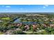 Expansive aerial view of luxury homes nestled among lush greenery and serene lakes in a vibrant community at 7580 Preservation Dr, Sarasota, FL 34241