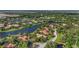 Stunning aerial view of waterfront homes surrounded by lush landscaping and a serene lake at 7580 Preservation Dr, Sarasota, FL 34241