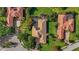 Birds eye view of a well-maintained home with a tile roof, pool, and lush, landscaped surroundings at 7580 Preservation Dr, Sarasota, FL 34241