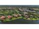 Beautiful aerial view showcasing luxury homes with tile roofs nestled among serene lakes and lush landscaping at 7580 Preservation Dr, Sarasota, FL 34241