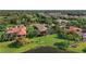 Expansive backyard featuring lush green lawn, mature trees, and serene pond views at 7580 Preservation Dr, Sarasota, FL 34241