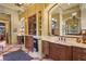 Elegant bathroom with double vanities, marble countertops, and custom wood cabinetry at 7580 Preservation Dr, Sarasota, FL 34241