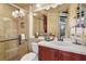 Well-lit bathroom featuring a tiled shower, single vanity, and decorative accents at 7580 Preservation Dr, Sarasota, FL 34241