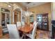 Charming dining room with chandelier, decorative display cabinet, and arched doorways, ideal for entertaining at 7580 Preservation Dr, Sarasota, FL 34241