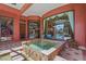 A tranquil fountain adjacent to the screened-in pool and patio area offers a serene backyard experience at 7580 Preservation Dr, Sarasota, FL 34241