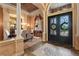 Elegant foyer showcases a decorative mosaic floor, ornate doors, and a chandelier, setting a tone of sophistication at 7580 Preservation Dr, Sarasota, FL 34241
