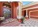 Inviting front entry features double doors, decorative columns, and a tiled walkway, creating a grand welcome at 7580 Preservation Dr, Sarasota, FL 34241