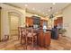 Well-appointed kitchen with a central island, custom wood cabinets, and modern stainless steel appliances at 7580 Preservation Dr, Sarasota, FL 34241