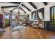 Bright living room boasts a vaulted ceiling with exposed beams, hardwood floors, and bay windows offering scenic views at 7580 Preservation Dr, Sarasota, FL 34241