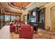 Comfortable living room featuring red leather seating, custom built-ins, and stylish décor accents at 7580 Preservation Dr, Sarasota, FL 34241