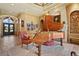 Living room featuring a grand piano, a decorative rug, and an antique easy chair at 7580 Preservation Dr, Sarasota, FL 34241