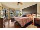 Spacious main bedroom featuring hardwood floors, a ceiling fan, and a sitting area with an abundance of natural light at 7580 Preservation Dr, Sarasota, FL 34241