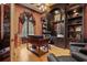 Executive office with custom built-ins, hardwood floors, and a comfortable workspace at 7580 Preservation Dr, Sarasota, FL 34241