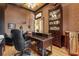 Office featuring a large desk, built-in bookcase, and decorative wallpaper at 7580 Preservation Dr, Sarasota, FL 34241