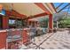 A spacious, screened outdoor bar and patio area is equipped with comfortable seating and lush landscaping at 7580 Preservation Dr, Sarasota, FL 34241