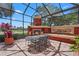 Relaxing screened patio features a fireplace, fountain, and outdoor seating area, perfect for entertaining or enjoying the view at 7580 Preservation Dr, Sarasota, FL 34241