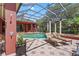 A screened-in pool area with lounge chairs, fountain, and well-manicured landscaping offers a private, relaxing retreat at 7580 Preservation Dr, Sarasota, FL 34241