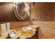 Chic powder room features a vessel sink, decorative mirror, and textured wallpaper at 7580 Preservation Dr, Sarasota, FL 34241