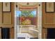 Shower with a seat and view of exterior greenery at 7580 Preservation Dr, Sarasota, FL 34241