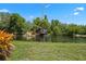 Picturesque water feature, a serene pond with a rock waterfall, surrounded by lush landscaping at 7580 Preservation Dr, Sarasota, FL 34241