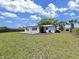 Backyard featuring a lush lawn, patio and mature trees at 7797 Barry Ct, Seminole, FL 33772