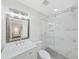 Modern bathroom with marble-tiled shower, glass door, and a stylish vanity at 7797 Barry Ct, Seminole, FL 33772