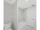 Bathroom with white marble tile and shower at 7797 Barry Ct, Seminole, FL 33772