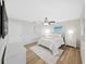 Bedroom featuring two windows, a ceiling fan, and wood floors at 7797 Barry Ct, Seminole, FL 33772