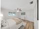 Bedroom with wood floors, ceiling fan, and a TV with a view of the town at 7797 Barry Ct, Seminole, FL 33772