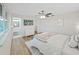 Bright bedroom featuring a ceiling fan and an attached bathroom at 7797 Barry Ct, Seminole, FL 33772