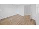 This is a bright bedroom with wood floors, a door, and an open doorway at 7797 Barry Ct, Seminole, FL 33772
