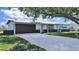 Charming single-story home with a well-manicured lawn and two-car garage at 7797 Barry Ct, Seminole, FL 33772