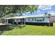 Charming single-story home with a well-manicured lawn and cute blue shutters at 7797 Barry Ct, Seminole, FL 33772