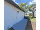 Side view of exterior showing door and blue patio at 7797 Barry Ct, Seminole, FL 33772